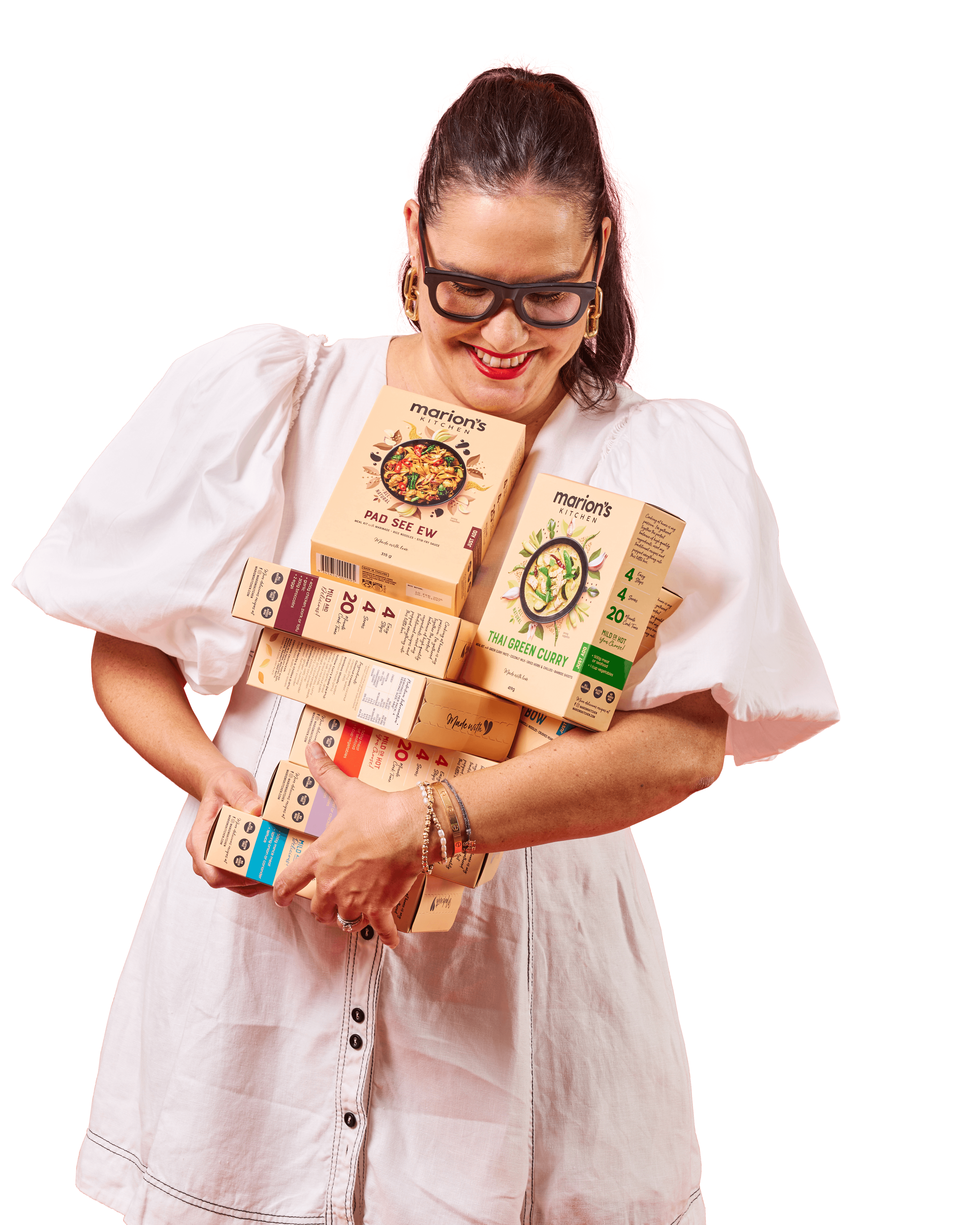 Marion Grasby holding Marion's Kitchen products