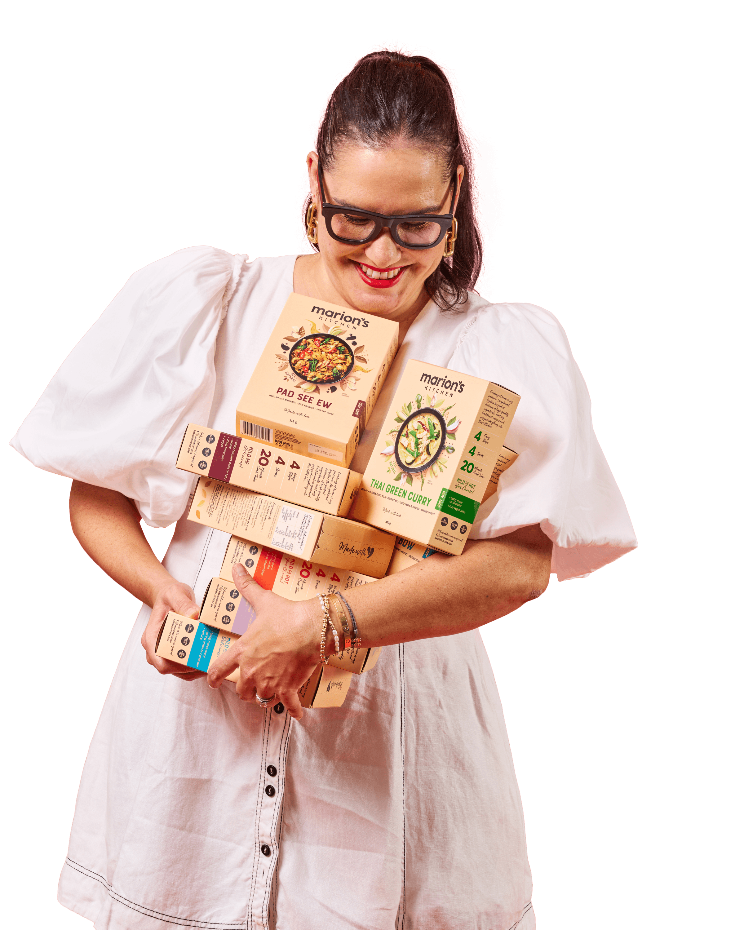 Marion Grasby holding Marion's Kitchen products